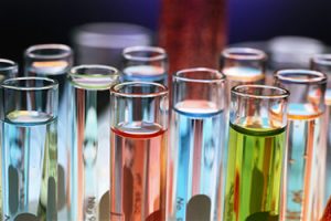 an array of test tubes filled with liquids for developing oral drug formulations